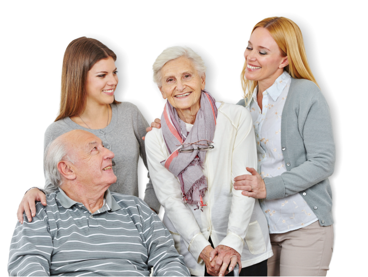 senior couple and two female caregivers smiling