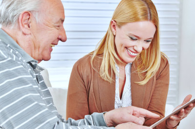 caregiver and senior man smiling