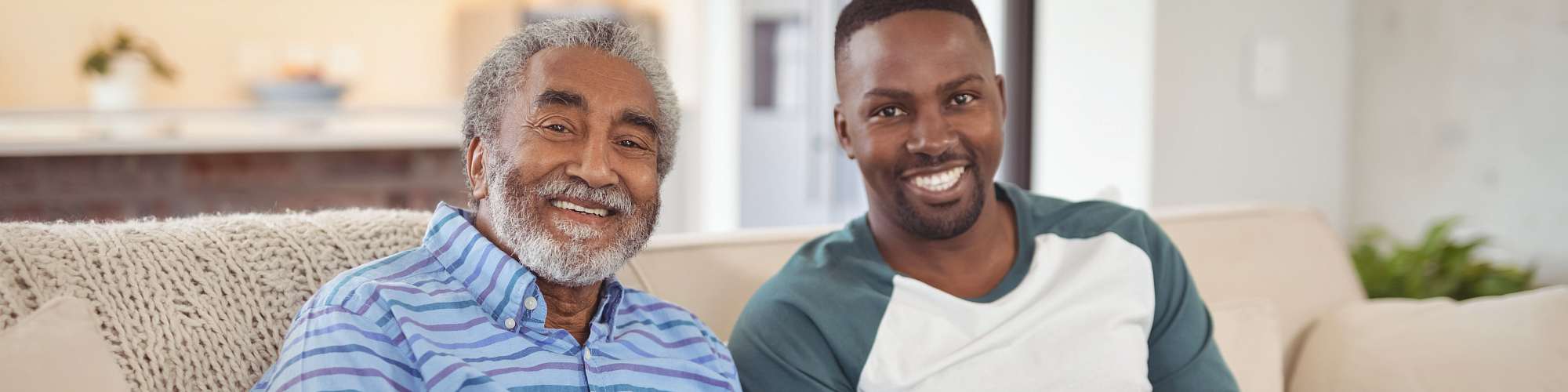 caregiver and senior man smiling