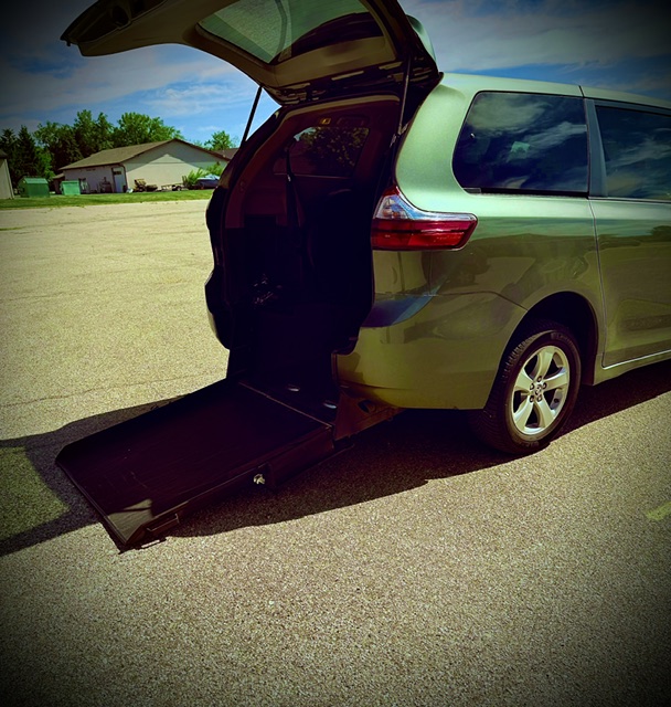 Wheelchair-accessible vehicle with rear ramp deployed